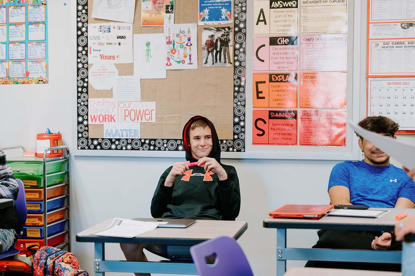 Students in their classroom, using a laptop to complete school assignments.