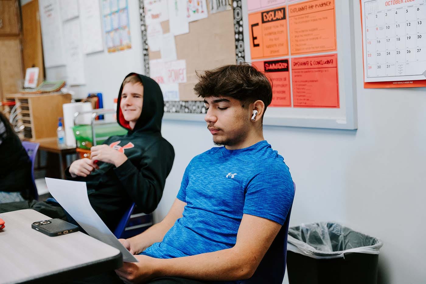 Students in their classroom, using a laptop to complete school assignments.