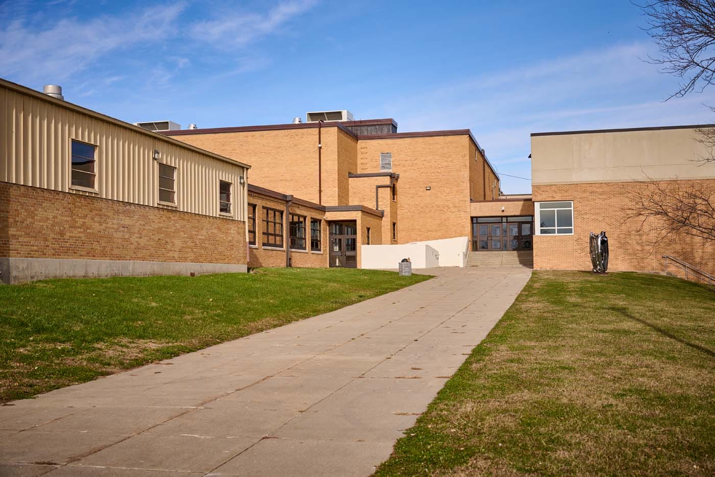 Exterior of Newton High School, a tan brick building.