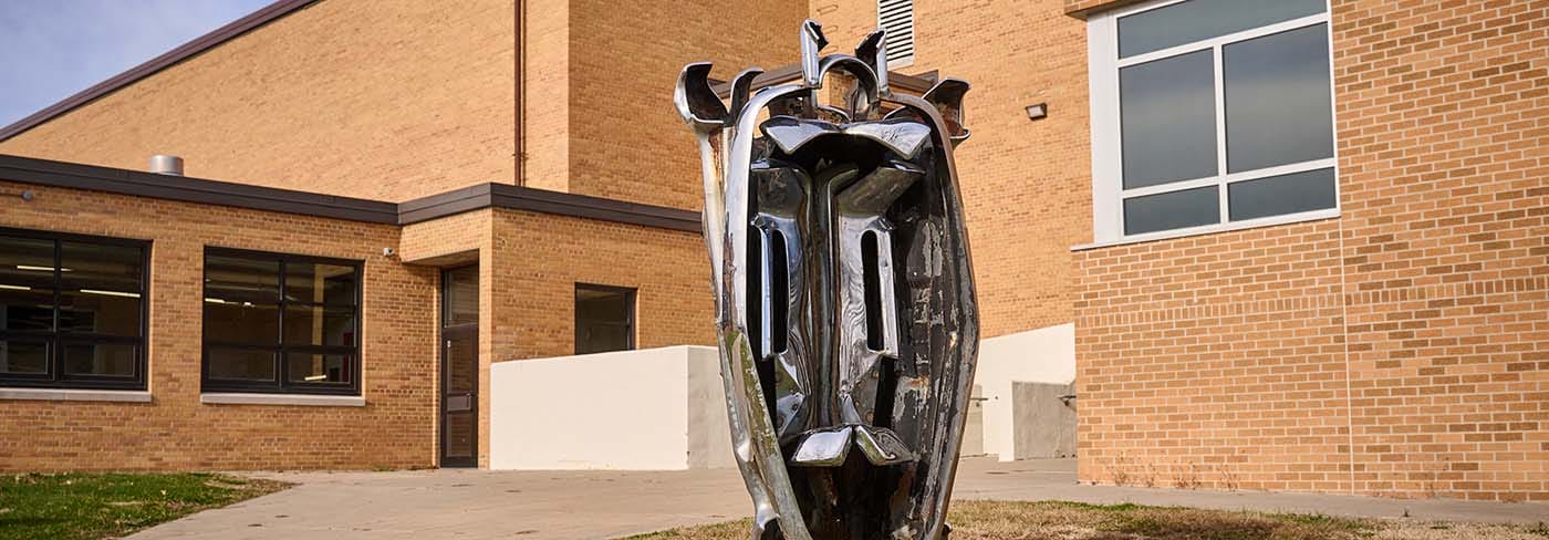 Exterior of Newton High School, a tan brick building.