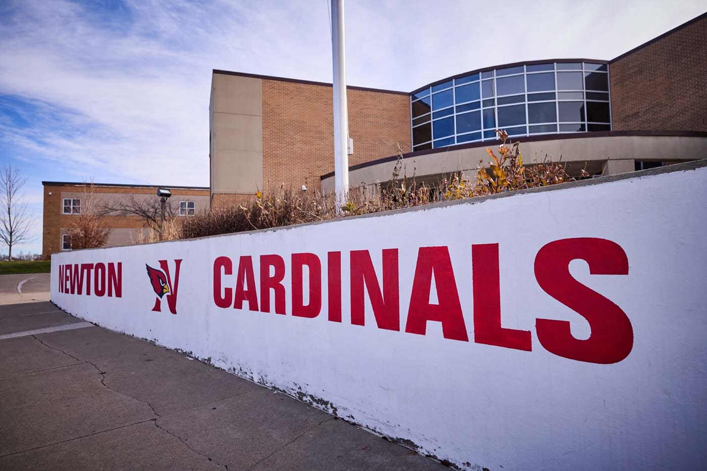 Exterior of Newton High School, a tan brick building.
